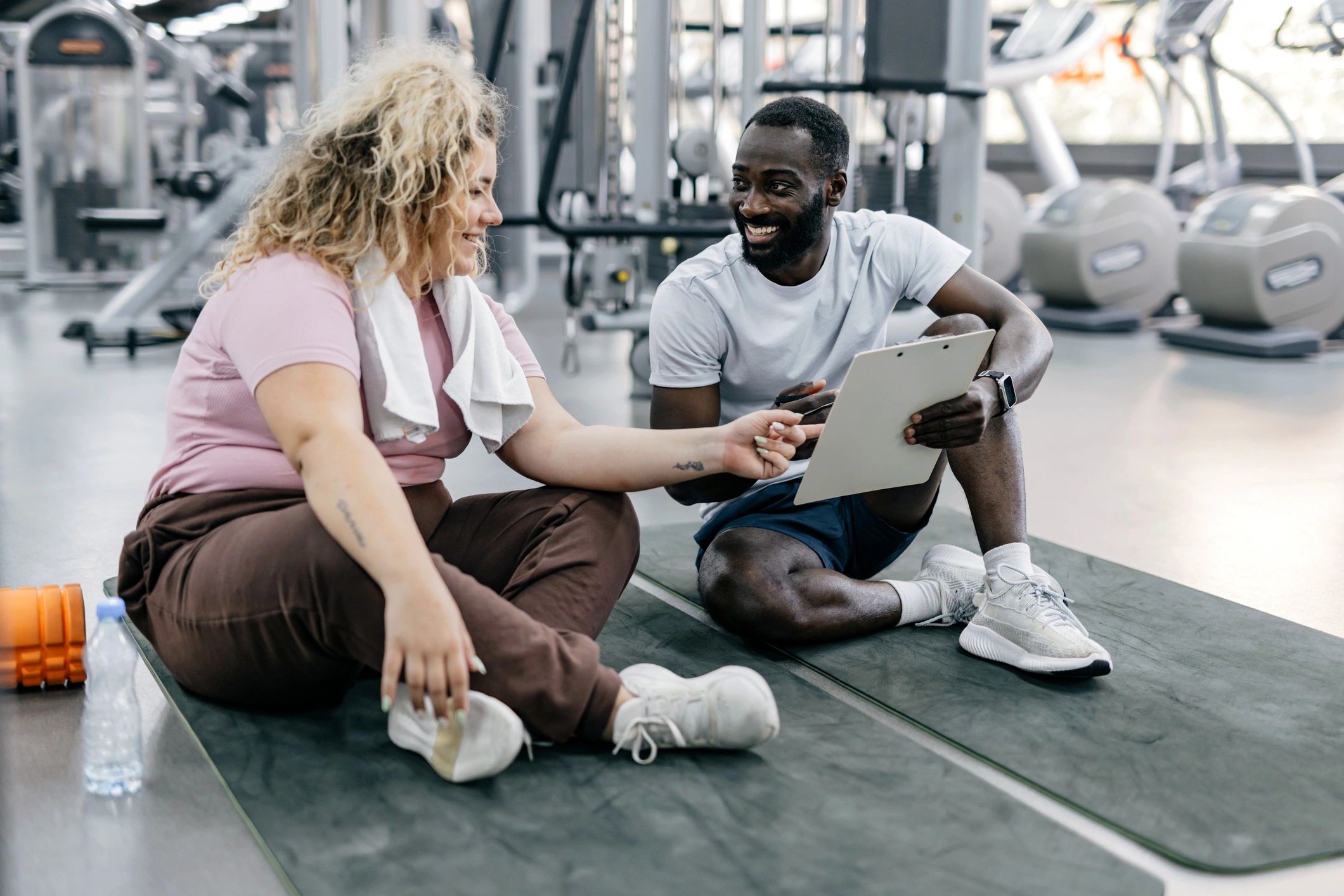 Personal trainer coaching a client in a gym