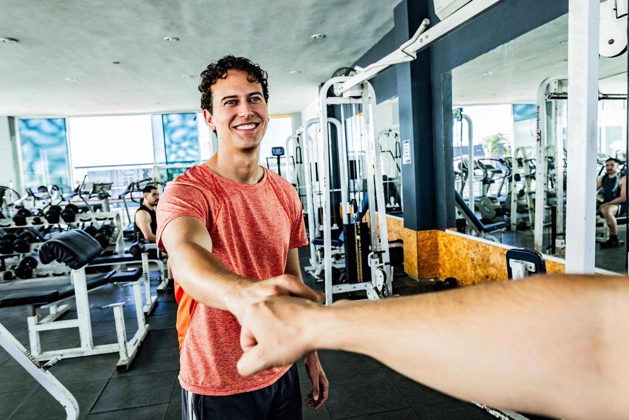 Gym members greeting each other in a friendly training environment
